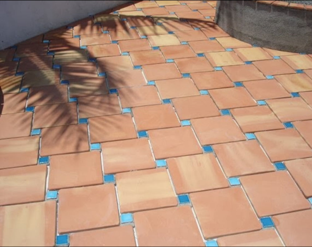 A sun-kissed ambiance created by Saltillo Salmon 8X8 natural terracotta, adding rich earthen tones and organic textures.