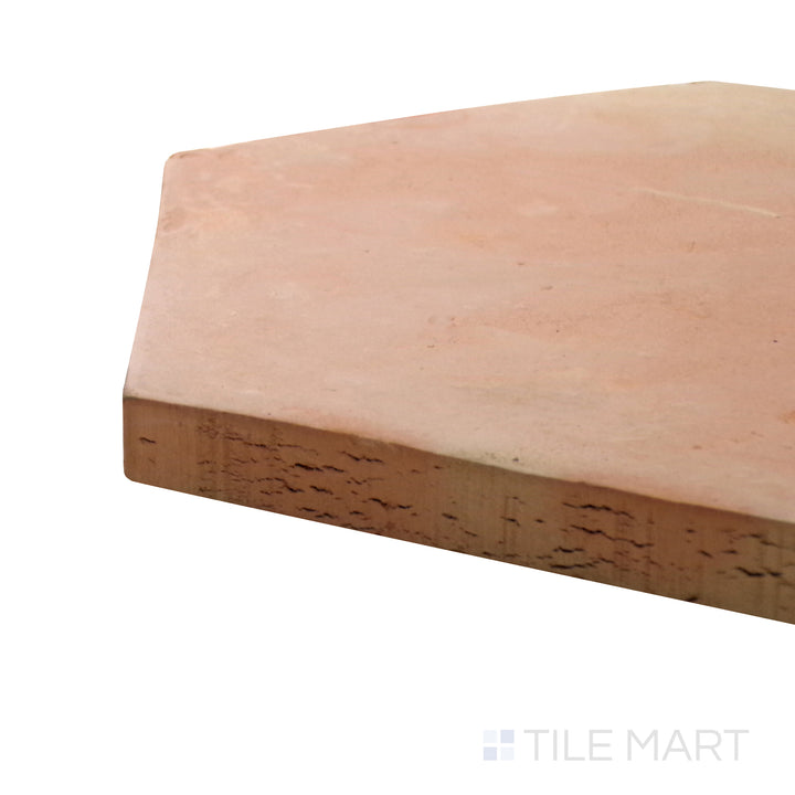 A corner shot of the Saltillo Salmon 8" hex natural terracotta tile highlights its hexagonal shape and warm salmon tones, creating a timeless and rustic flooring option.
