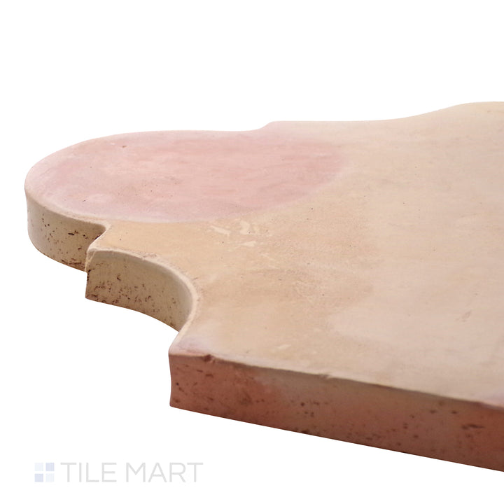 A corner shot of the Saltillo Salmon 9x11 San Felipe natural terracotta tile highlights its curved edges and textured surface, perfect for traditional and rustic aesthetics.