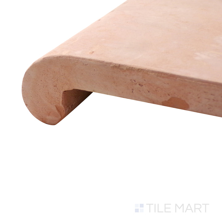 A corner shot of the Saltillo Salmon 12x12 stair coping natural terracotta tile highlights its rounded edges and rich salmon hue, offering a seamless finish for steps and edges.