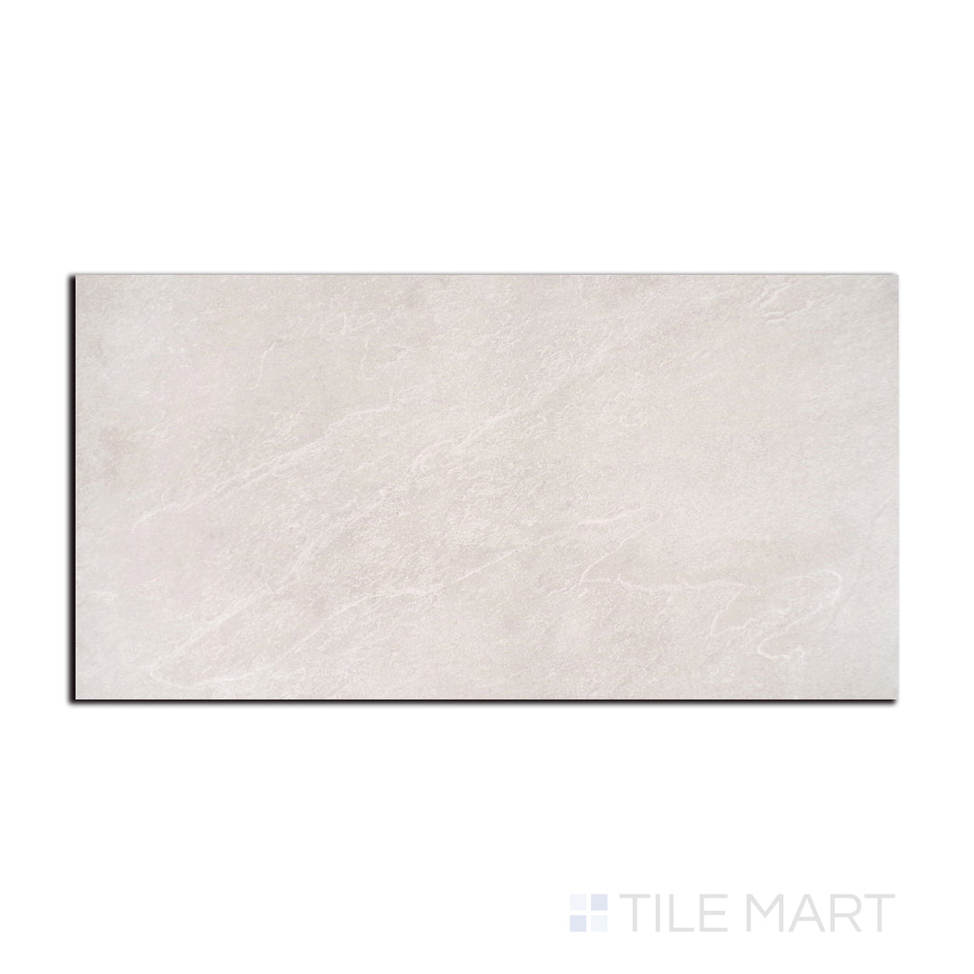 Flat lay of Nordika Sand 24X48 Matte Porcelain, displaying its warm sandy hues and subtle texture for a natural stone effect.