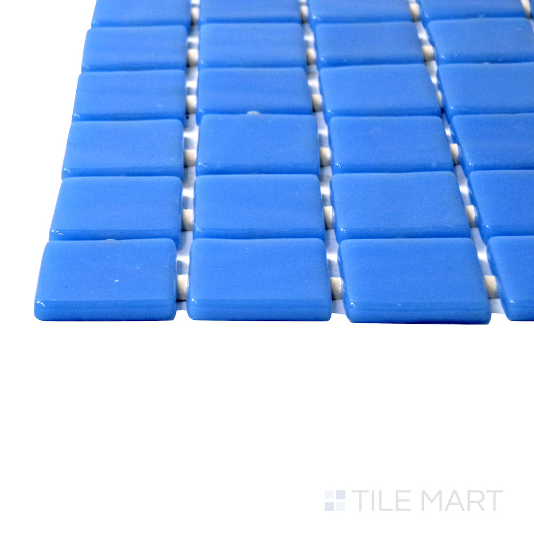 Captured from a corner angle, the Lisa Azul Claro 1" square glossy glass mosaic tile showcases its light blue hue and reflective glossy surface, adding a fresh and coastal vibe to any space.