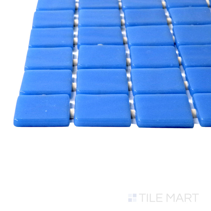 Captured from a corner angle, the Lisa Azul Claro 1" square glossy glass mosaic tile showcases its light blue hue and reflective glossy surface, adding a fresh and coastal vibe to any space.