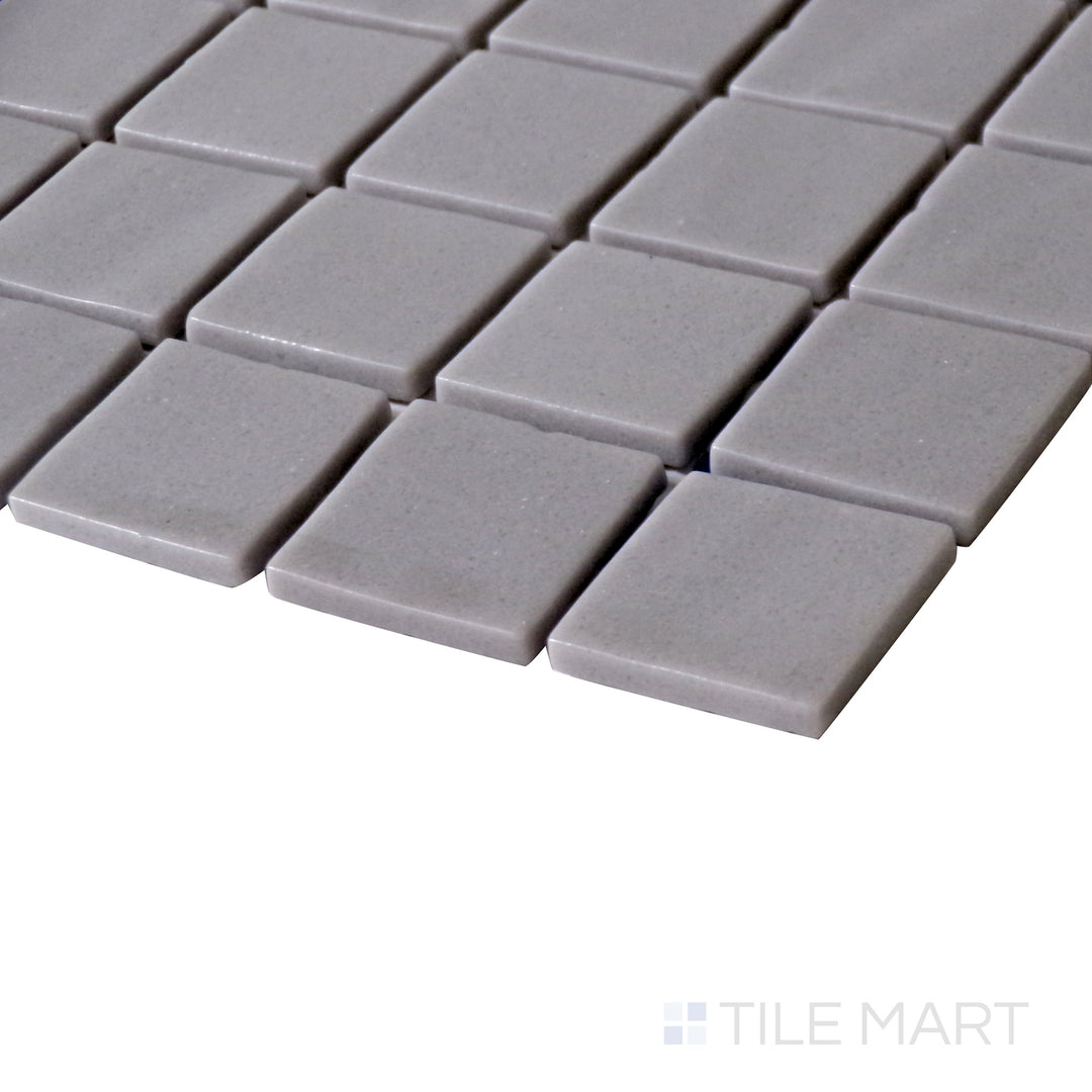 Side perspective emphasizing the neutral, refined look of Natureglass Malla Grey 1" square matte glass mosaic.