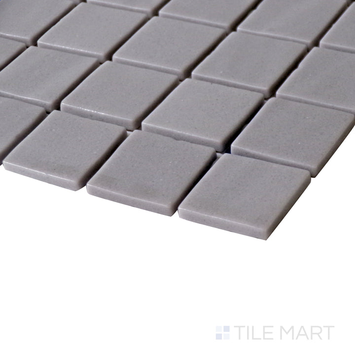 Side perspective emphasizing the neutral, refined look of Natureglass Malla Grey 1" square matte glass mosaic.
