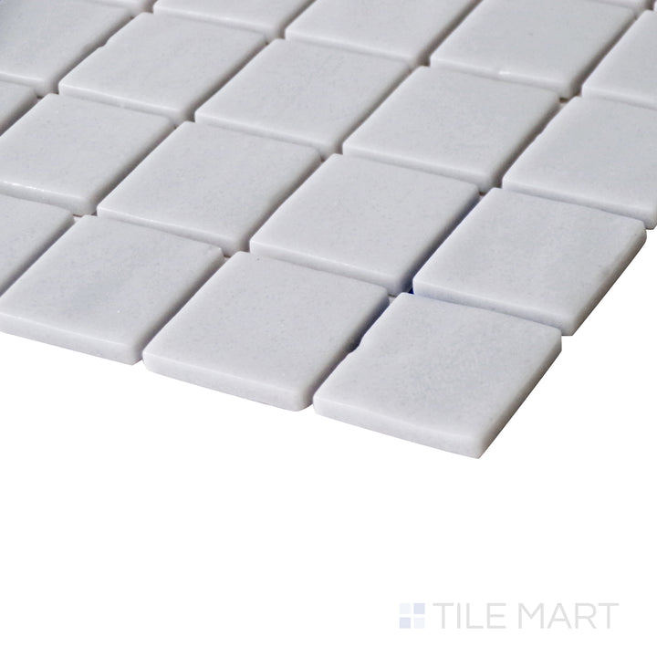 Tilted shot showcasing the soft, contemporary finish of Natureglass Malla Smooth Grey 1" square matte glass mosaic.