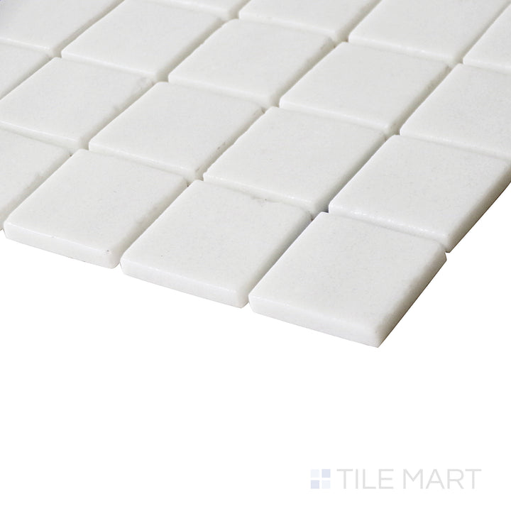 Angled view highlighting the crisp, clean aesthetic of Natureglass Malla White 1" square matte glass mosaic.