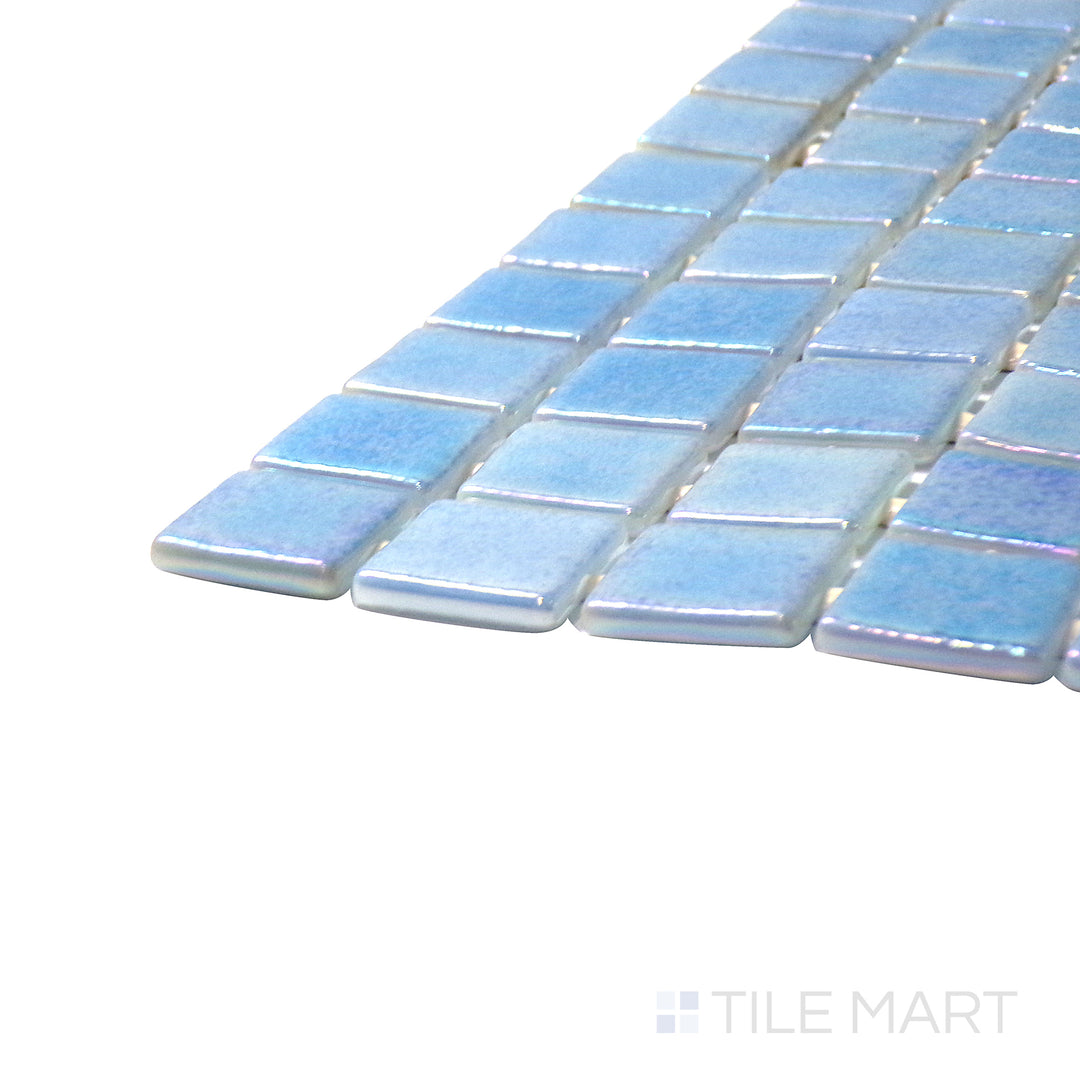 Captured from a corner angle, the Opalescent Celeste Azul 1" square glossy glass mosaic tile showcases its radiant blue hue and reflective finish, creating a striking and vibrant accent.