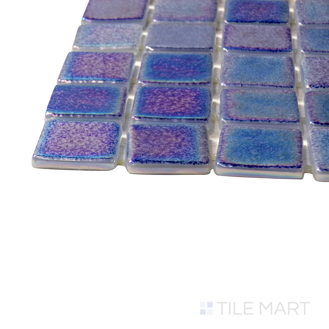 A corner shot of the Opalescent Marino Azul 1" square glossy glass mosaic tile highlights its deep ocean blue color and smooth reflective texture, perfect for creating a bold and stylish statement.