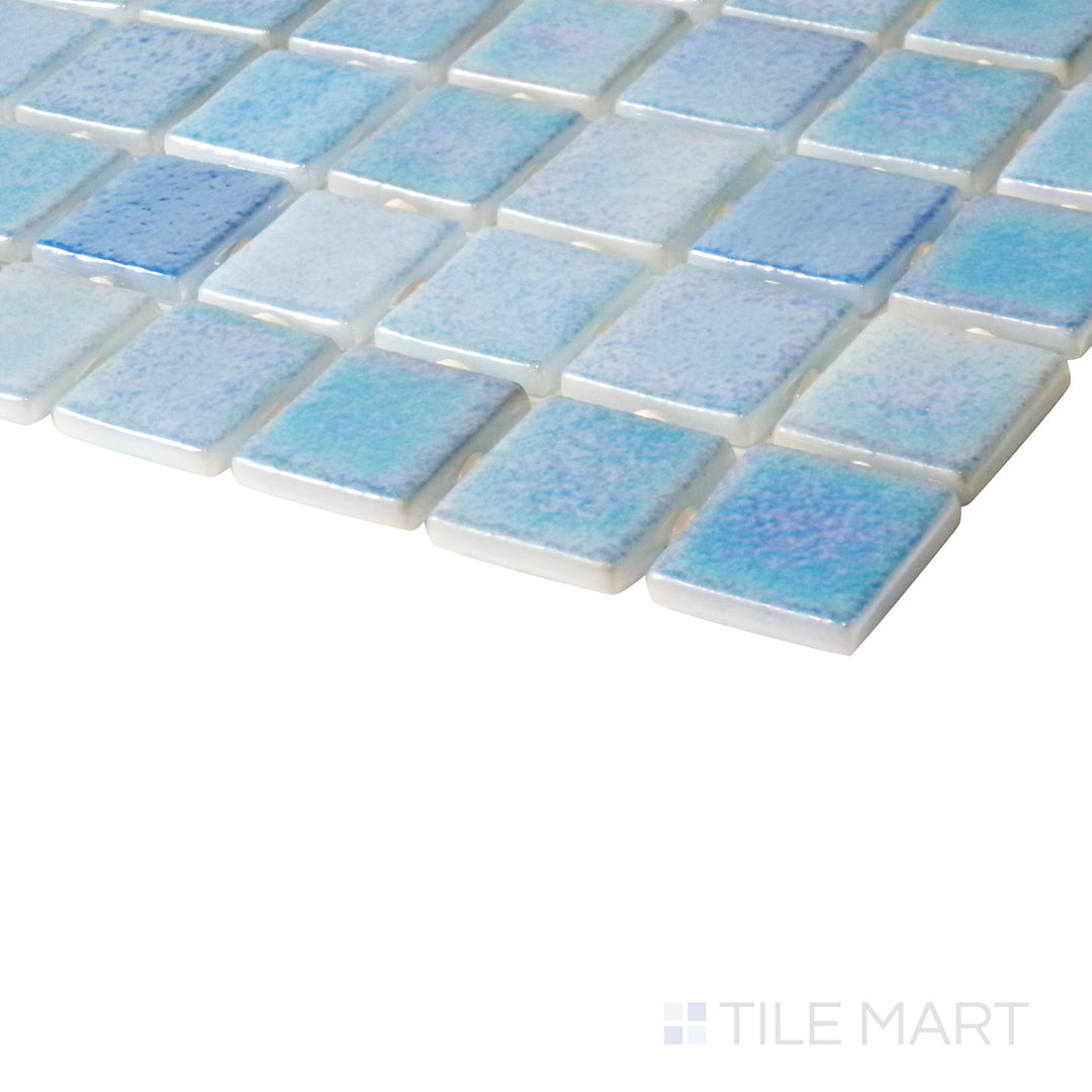 Tilted shot showcasing the dynamic color blend of Opalescent Mix Azul 1" square glossy glass mosaic.