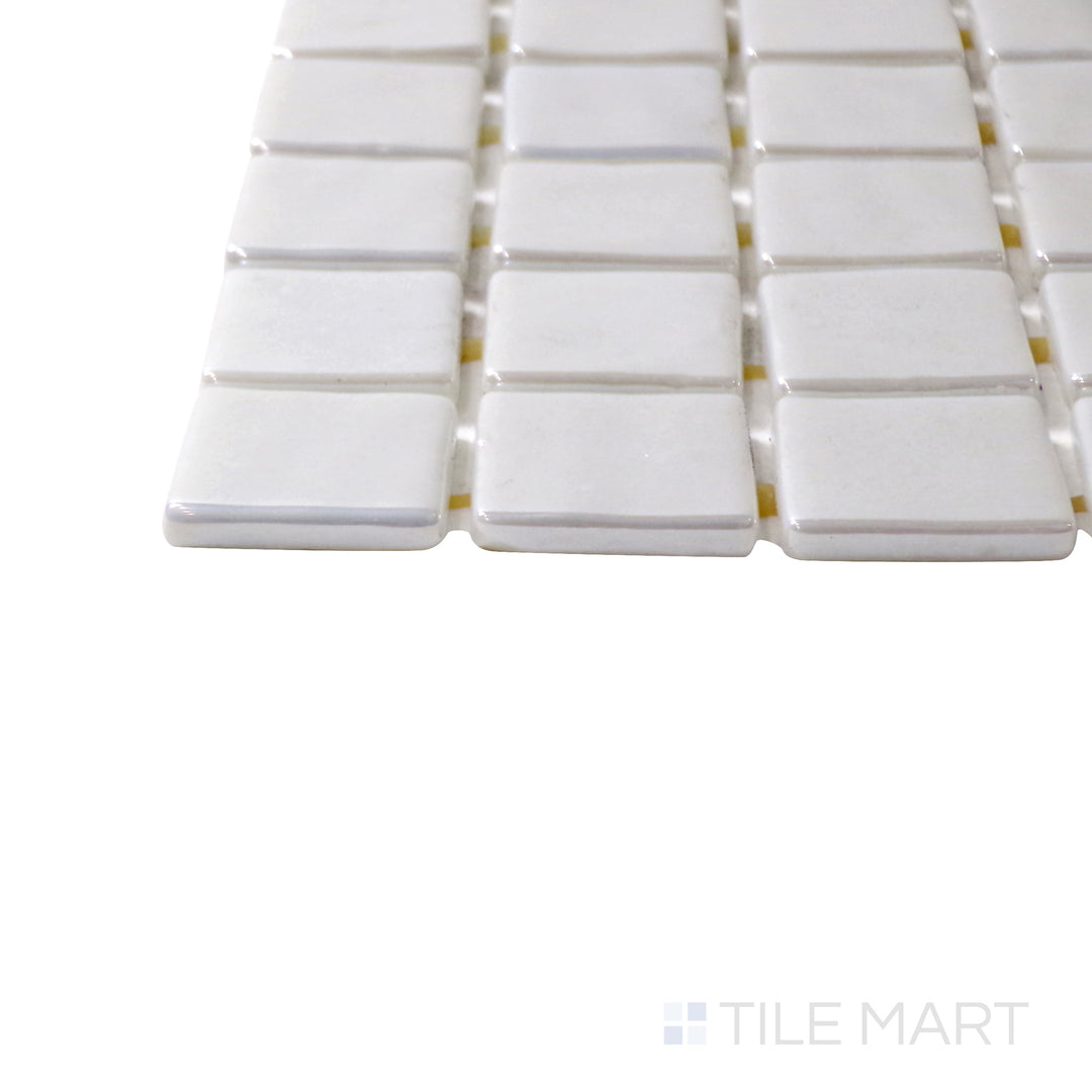 A corner shot of the Opalo Blanco 1" square glossy glass mosaic tile highlights its crisp white finish and reflective surface, offering a timeless and elegant appeal.