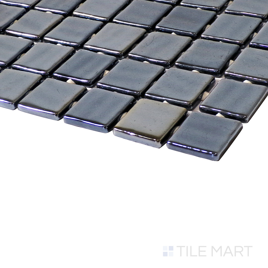 A striking angle shot showcasing the sleek Opalo Negro 1" square glossy glass mosaic, capturing depth, shine, and intricate detailing.
