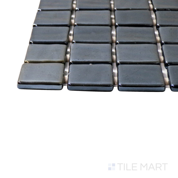 Captured from a corner angle, the Opalo Negro 1" square glossy glass mosaic tile showcases its deep black tones and high-gloss finish, adding a bold and modern aesthetic.