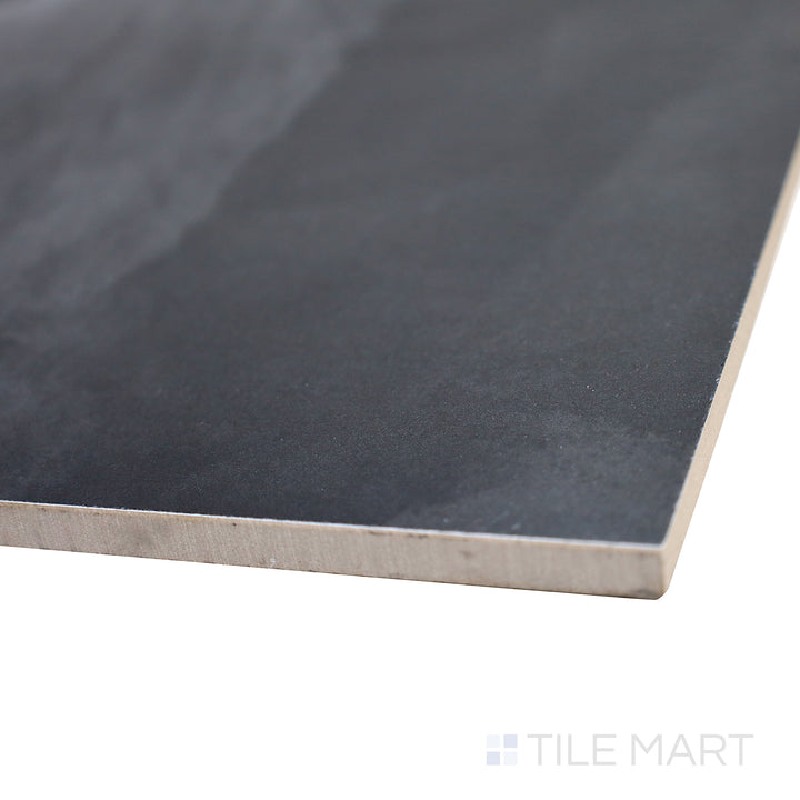 Tilted view showcasing the bold, sophisticated depth of Onyx Black 24X48 polished porcelain tile.