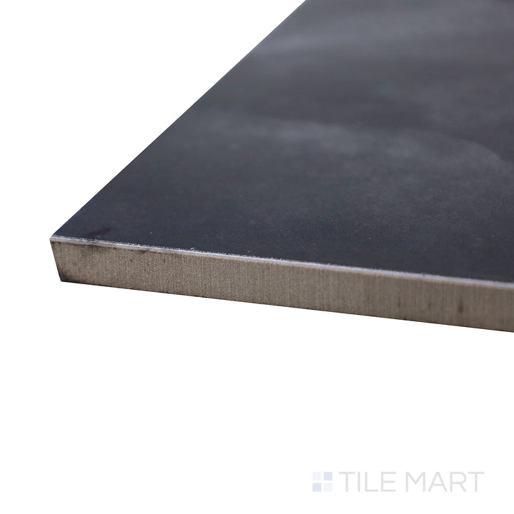 A corner shot of the Onyx Black 24x48 polished porcelain tile highlights its deep black finish with subtle veining, offering a luxurious and dramatic marble-inspired appearance.