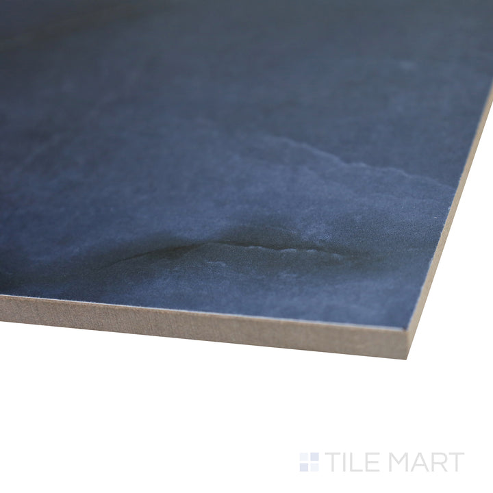 Angled shot emphasizing the striking, deep blue luxury of Onyx Blue 24X48 polished porcelain tile.