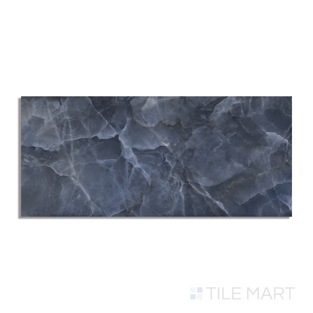 A deep blue polished porcelain tile in a large 24x48 format, with a mirror-like sheen, captured from an overhead perspective for a clear look at its texture.