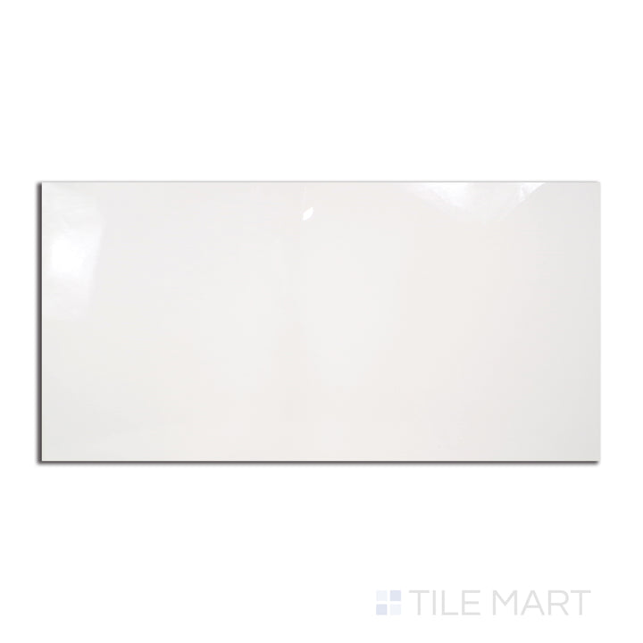 A glossy 12x24 polished porcelain tile in a pure white hue, arranged in a rectangular format, viewed from above to highlight its reflective sheen.