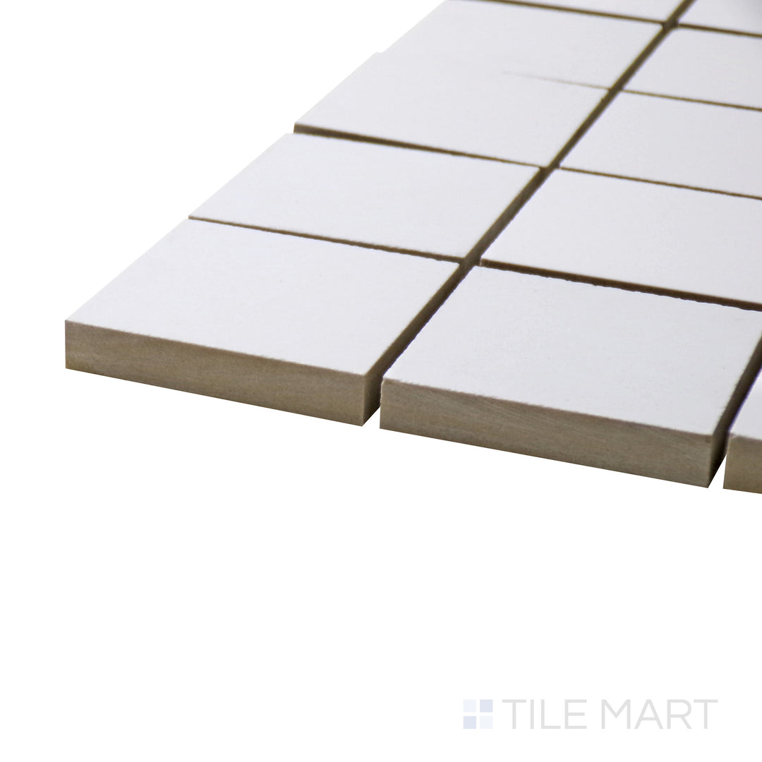 Captured from a corner angle, the Pearl Super White 2" square polished porcelain mosaic tile showcases its reflective surface and brilliant white hue, perfect for backsplashes and accent walls.