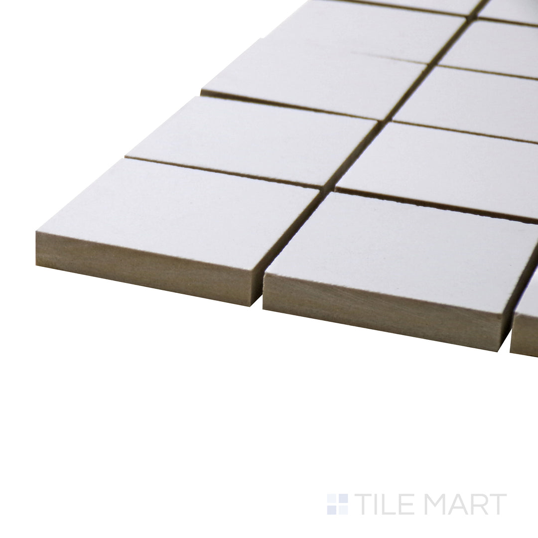 A corner perspective of the Pearl Super White 2" square matte porcelain mosaic tile emphasizes its smooth texture and versatile white tone, offering a subtle yet refined aesthetic.