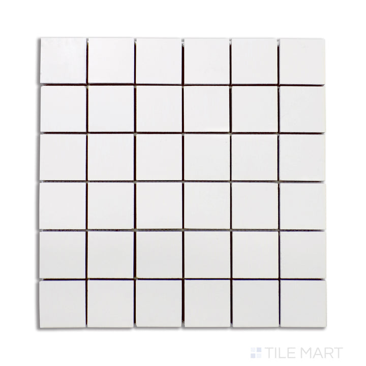 A refined matte porcelain mosaic in a 2-inch square pattern, featuring a bright Pearl Super White tone, arranged uniformly and shown from an overhead perspective.