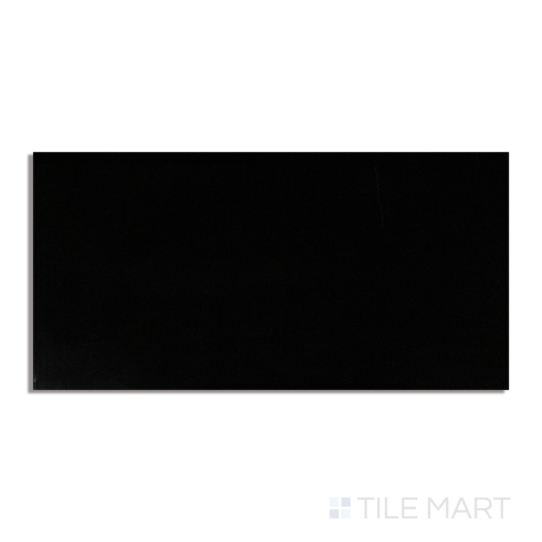 A dramatic black polished porcelain tile in a 24x48 format, with a high-gloss finish, captured from a top-down view to highlight its reflective surface.