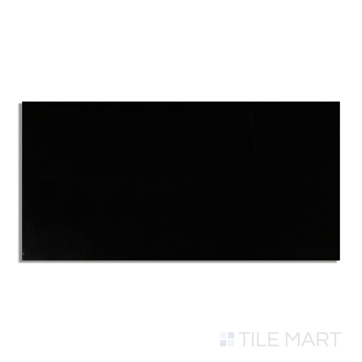 A dramatic black polished porcelain tile in a 24x48 format, with a high-gloss finish, captured from a top-down view to highlight its reflective surface.