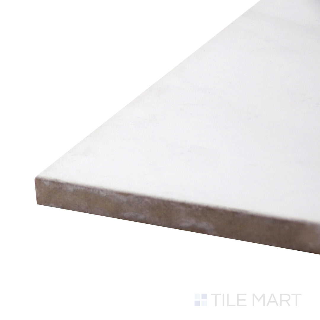 Captured from a corner angle, the Polished Stone Calacatta 24x24 porcelain tile emphasizes its crisp white base and flowing gray veining, evoking a timeless marble look.