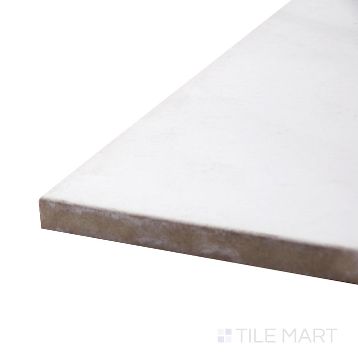 Captured from a corner angle, the Polished Stone Calacatta 24x24 porcelain tile emphasizes its crisp white base and flowing gray veining, evoking a timeless marble look.