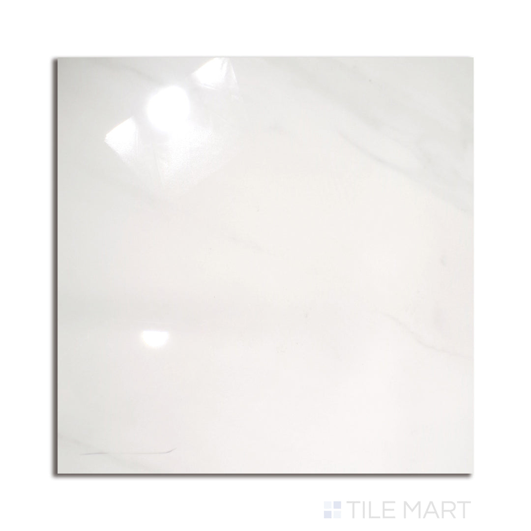 A striking 24x24 Calacatta-inspired polished porcelain tile, boasting bold grey veining on a luminous white background, presented from a top-down perspective.