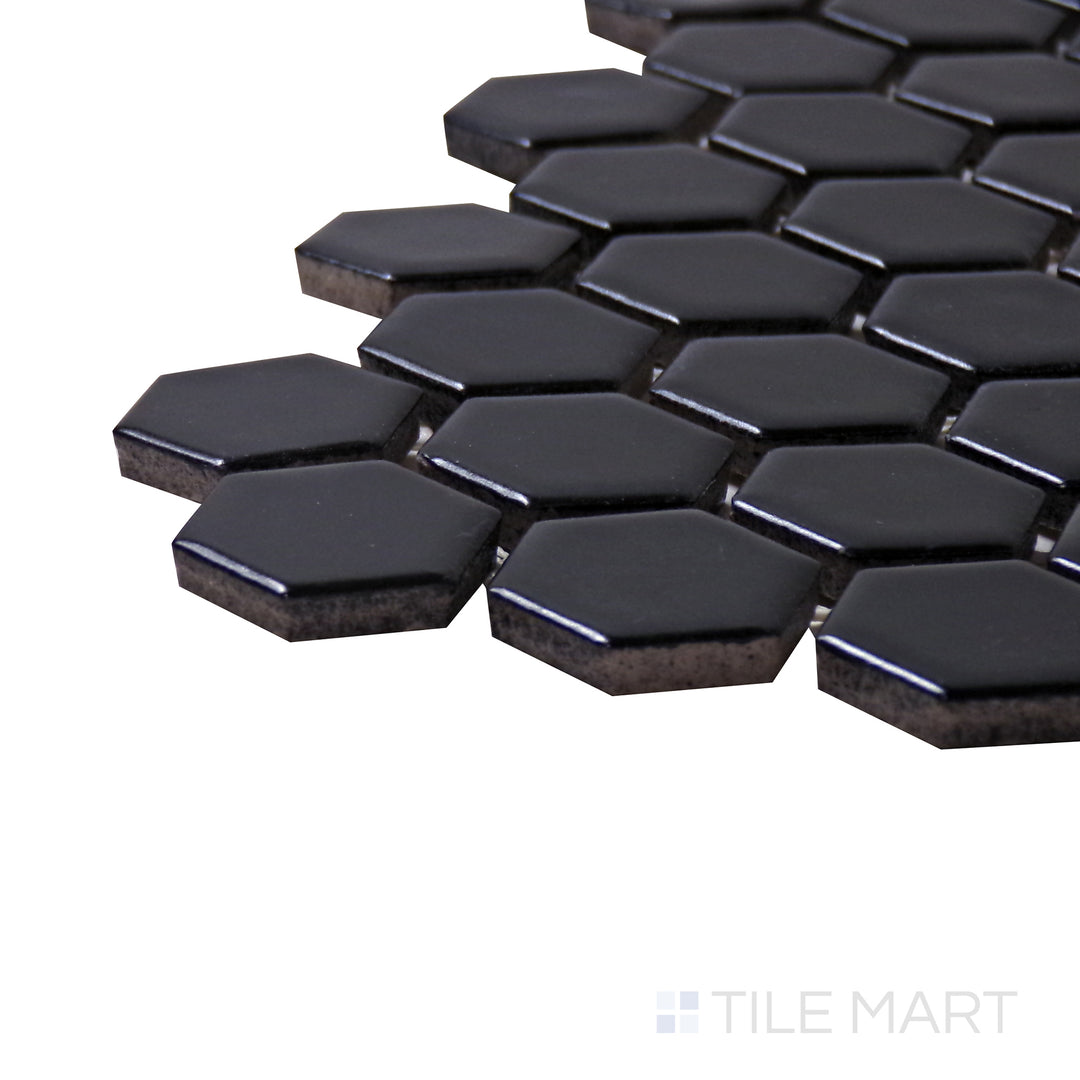 A corner shot of the Porcelain Glazed Mosaics Black 1" hexagon matte tile highlights its deep black color and smooth matte finish, ideal for bold, modern designs.