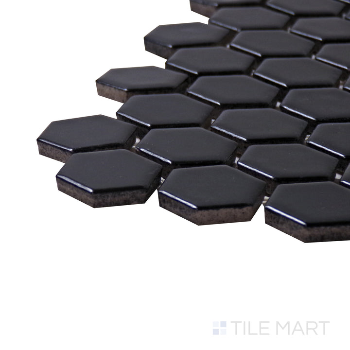 A corner shot of the Porcelain Glazed Mosaics Black 1" hexagon matte tile highlights its deep black color and smooth matte finish, ideal for bold, modern designs.