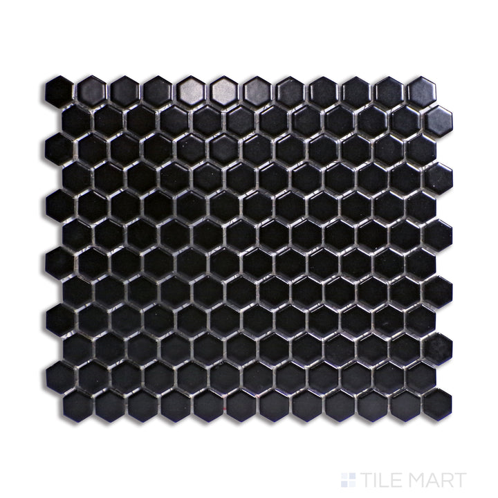 A sleek black 1-inch hexagon matte porcelain mosaic tile, arranged in a honeycomb pattern, displayed from a top-down view to highlight its geometric design.