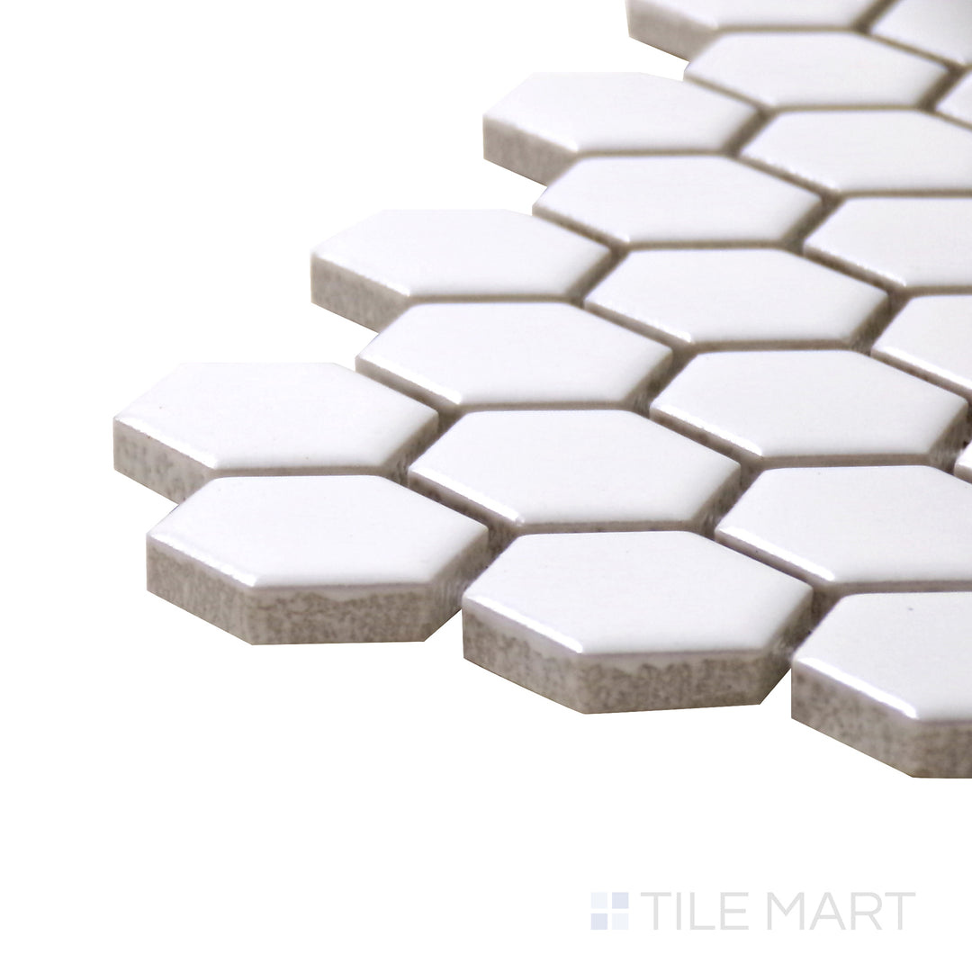 A corner perspective of the Porcelain Glazed Mosaics White 1" hexagon matte tile emphasizes its clean white color and smooth finish, perfect for brightening up interiors.