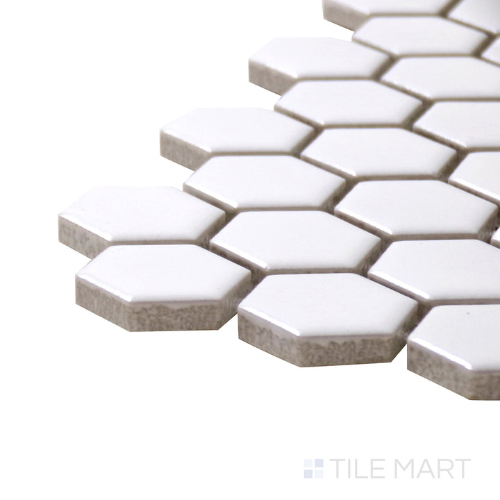 A corner perspective of the Porcelain Glazed Mosaics White 1" hexagon matte tile emphasizes its clean white color and smooth finish, perfect for brightening up interiors.