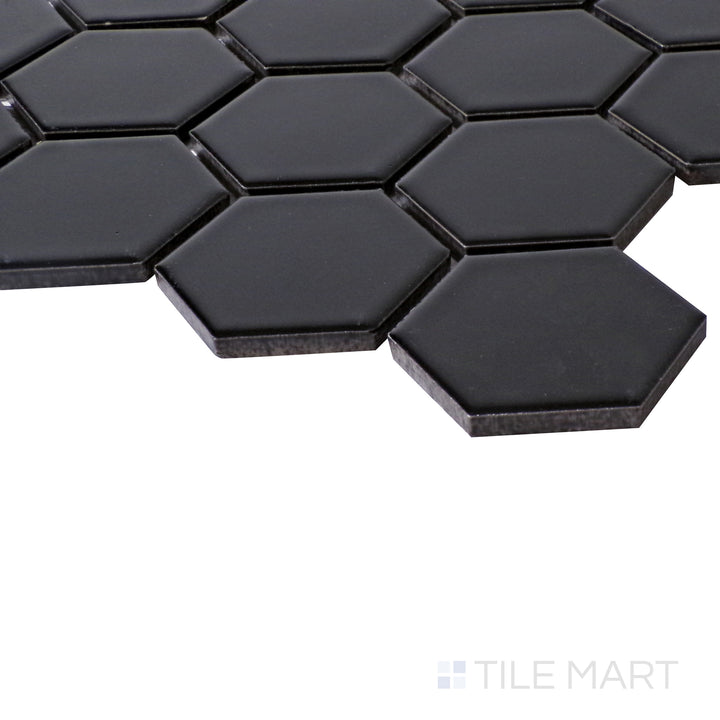 Close-up angle emphasizing the bold, rich shade of Porcelain Glazed Black 2" Hexagon Matte mosaic.