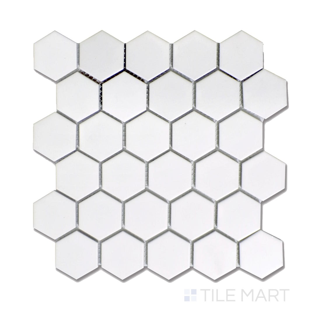 A clean white 2-inch hexagonal matte mosaic tile, arranged in a timeless honeycomb pattern, displayed from an overhead perspective for full detail.