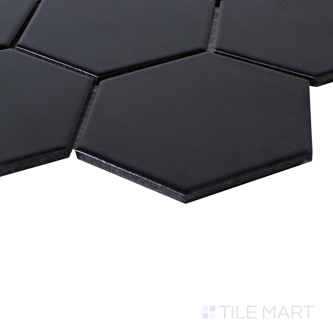 Angled close-up showing the bold and dramatic look of Porcelain Glazed Black 4" Hexagon Matte mosaic.
