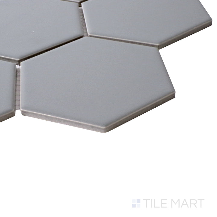 Side perspective highlighting the sleek, neutral tone of Porcelain Glazed Gray 4" Hexagon Matte mosaic.