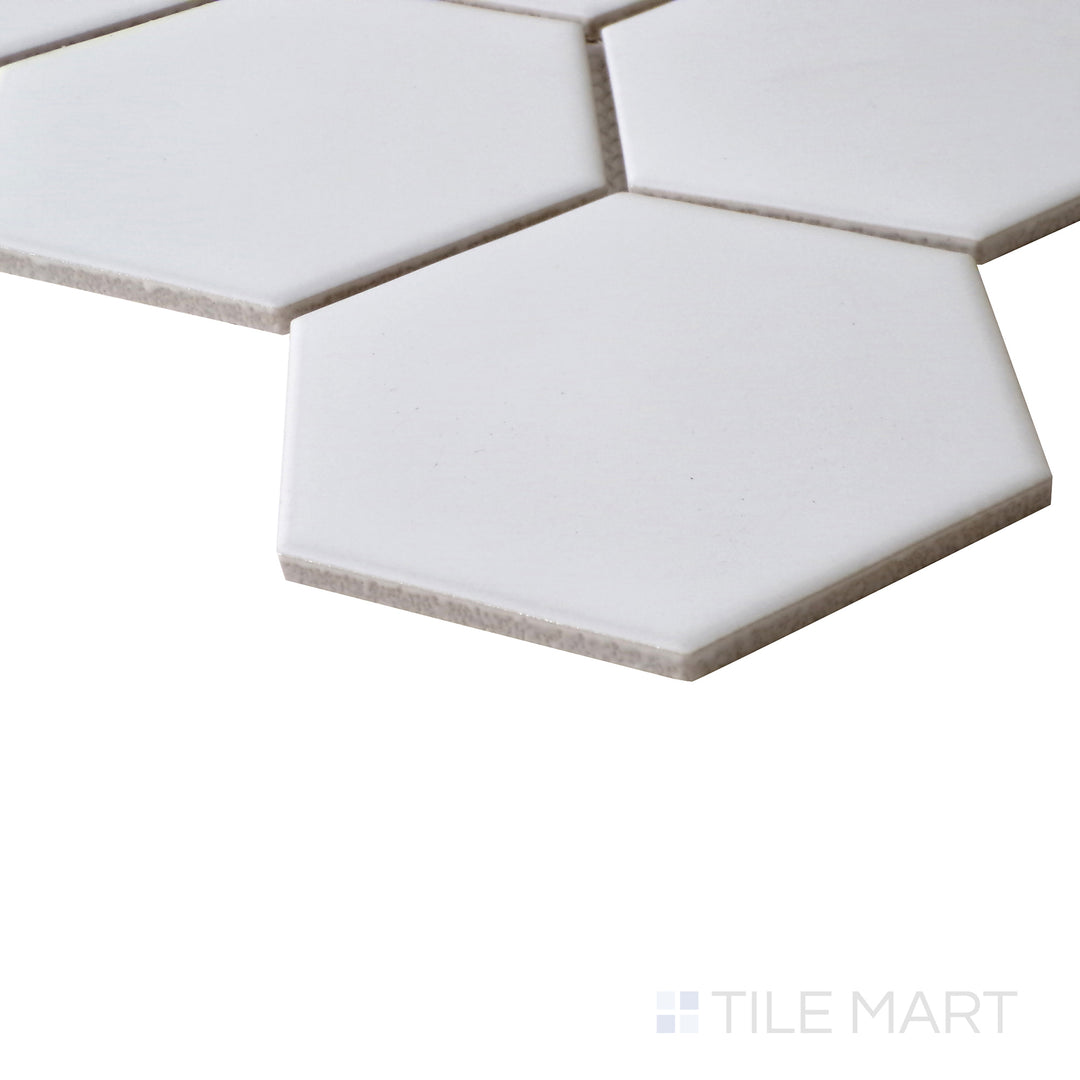 Tilted view capturing the clean, minimalist appeal of Porcelain Glazed White 4" Hexagon Matte mosaic.