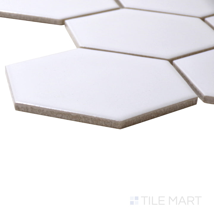 A corner perspective of the Porcelain Glazed Mosaics White 4" hexagon matte tile highlights its classic white color and hexagonal pattern, offering a clean and minimalist aesthetic.