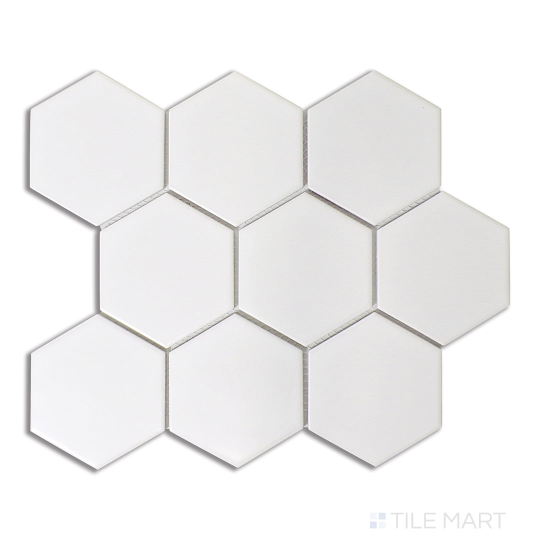 A luminous white 4-inch hexagonal matte porcelain mosaic, showcasing a minimalist honeycomb layout, viewed from a bird’s-eye angle for sharp contrast.