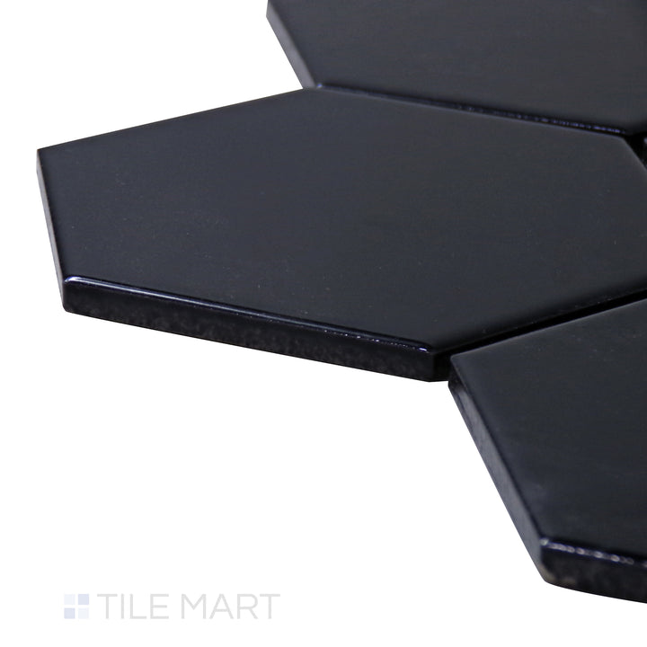 A corner shot of the Porcelain Glazed Mosaics Black 4" hexagon glossy tile showcases its high-gloss surface and bold black tone, adding a luxurious sheen to walls and floors.
