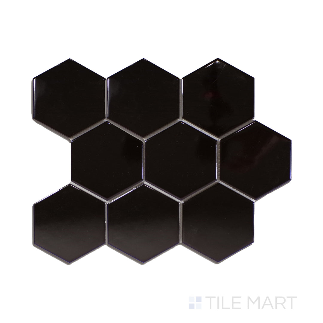 A striking black 4-inch hexagonal glossy porcelain mosaic, offering a reflective surface, displayed from an overhead perspective to accentuate its sheen.