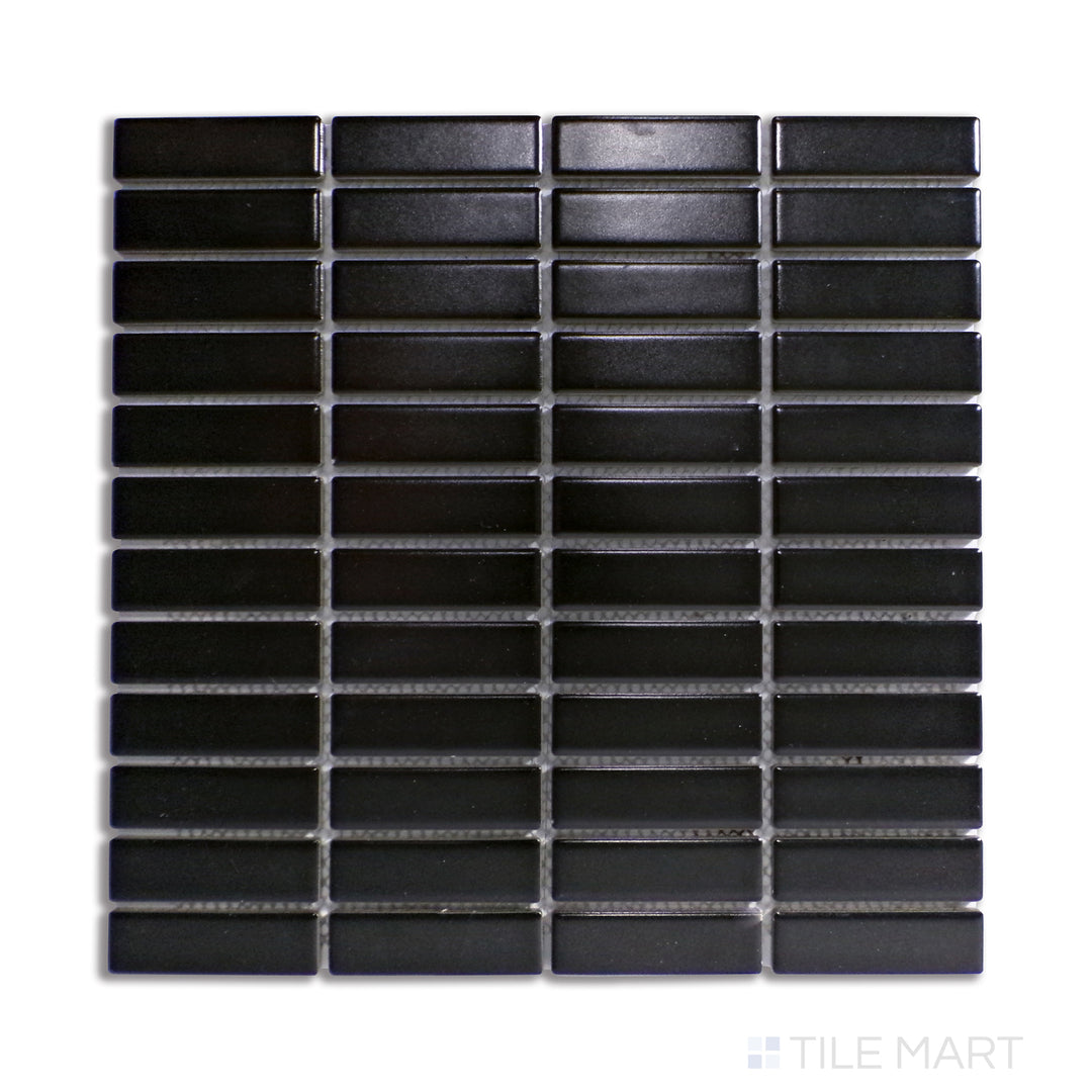 A bold black matte porcelain mosaic with a structured grid pattern, displayed from above to highlight its precise alignment and strong contrast.