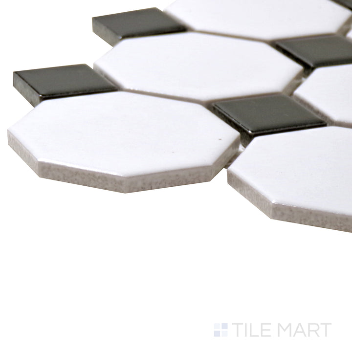 A corner shot of the Porcelain Glazed Mosaics White With Black Dot 2" Octagon Matte tile emphasizes its intricate octagonal shape and contrasting black dot accents.