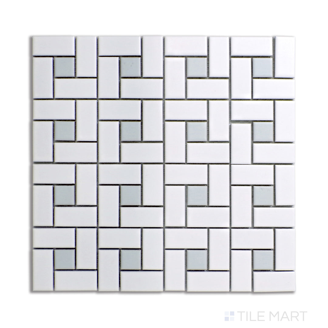 Top-down angle of a white pinwheel mosaic tile design, featuring matte-finished porcelain with delicate gray dot accents for a neutral aesthetic.