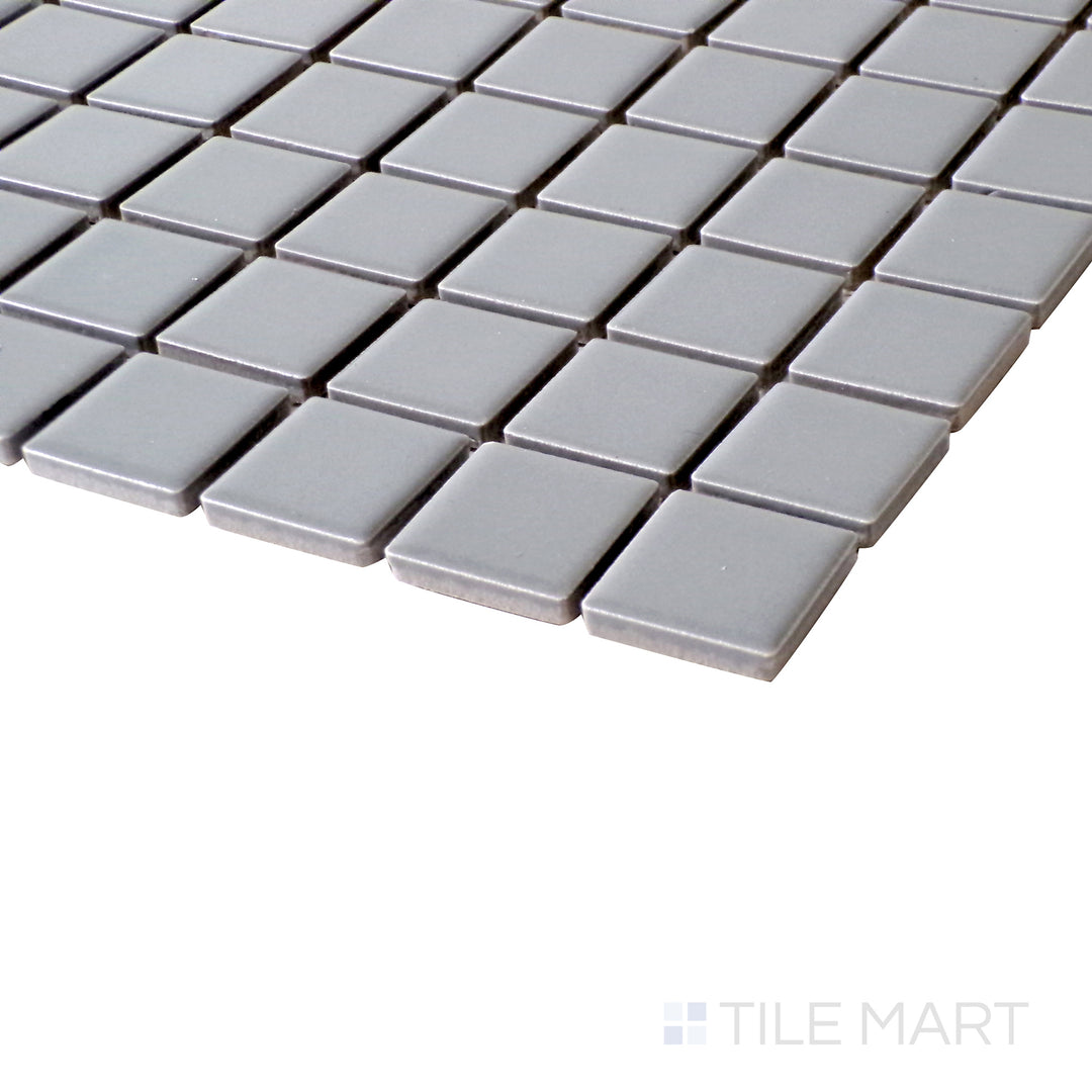 A close-up angle showcasing the refined texture and soft neutral tones of Gray 1" Square Matte Porcelain Glazed Mosaics.