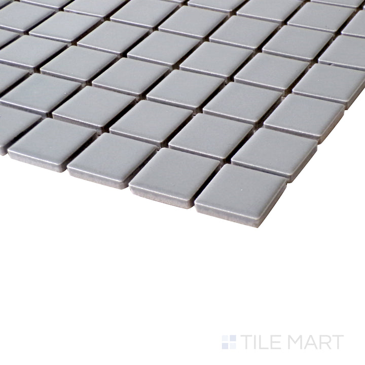 A close-up angle showcasing the refined texture and soft neutral tones of Gray 1" Square Matte Porcelain Glazed Mosaics.