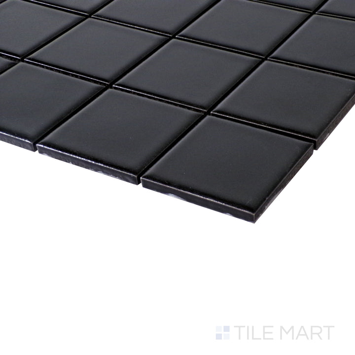 An angled perspective highlighting the bold contrast and smooth matte finish of Black 2" Square Matte Porcelain Glazed Mosaics.